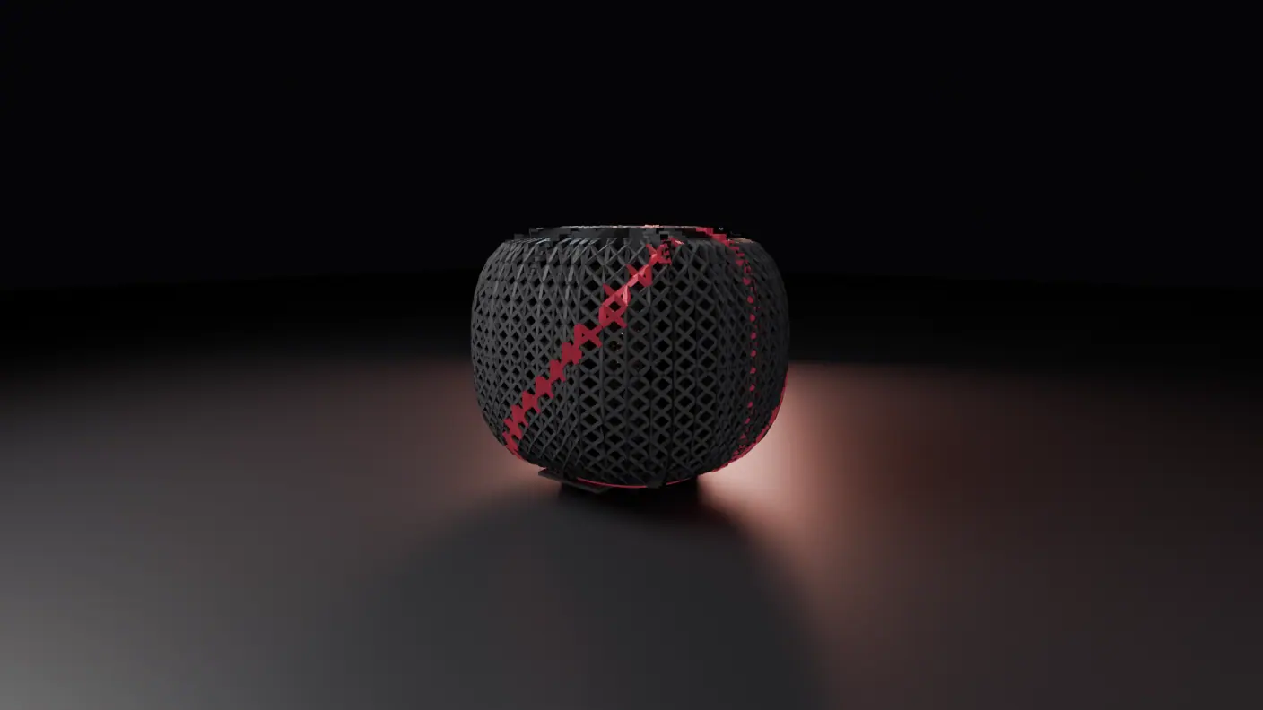 A dark machine alone on the floor of an unlit studio, a rounded pillow-shaped body whose entire surface is a woven lattice of small crossed struts in matte charcoal, with one deep-red line winding diagonally up and around it.