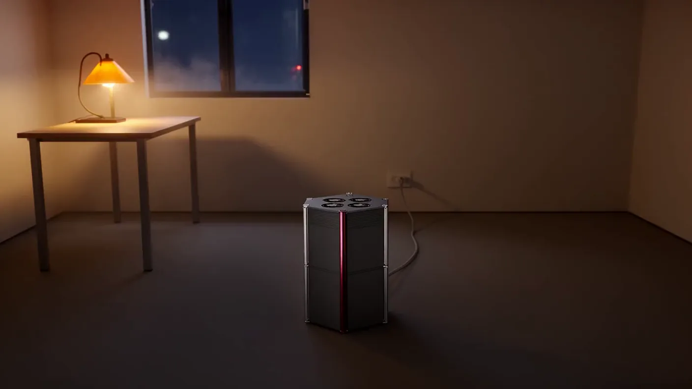 A small locked room with one machine on the floor, a tall dark hexagonal enclosure with a garnet edge.